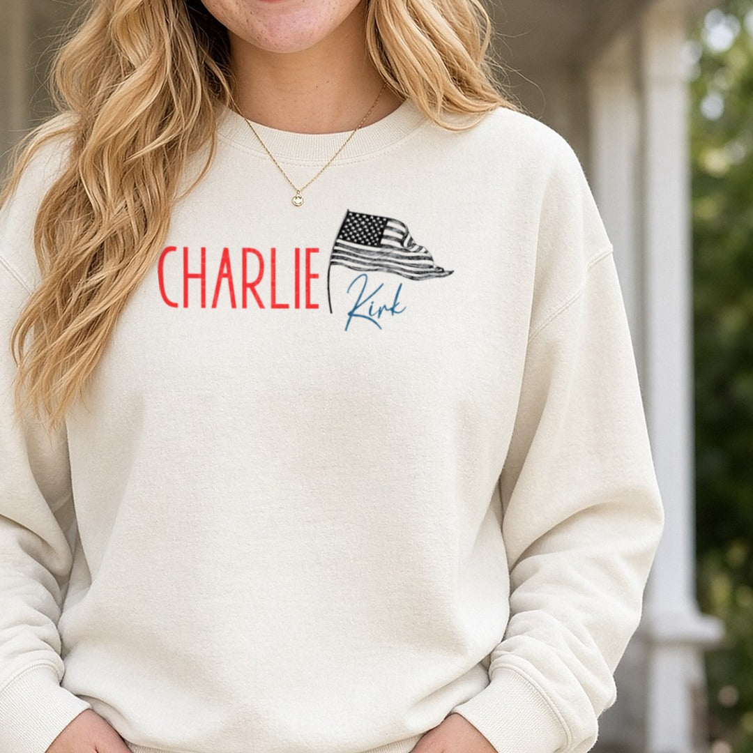 Charlie Kirk Red Letters Waving Flag DTF transfer shown on a Comfort Colors sweatshirt