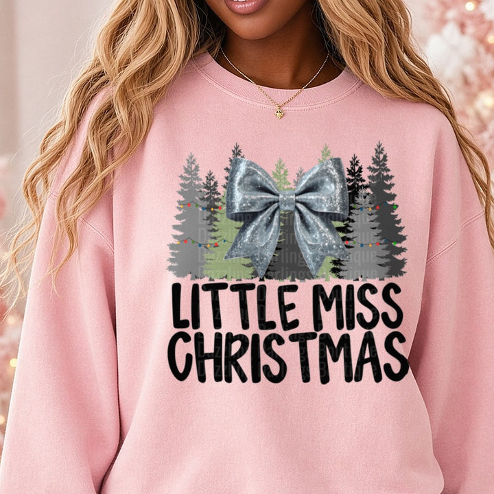 Silver Bow Little Miss Christmas DTF transfer shown on a Comfort Colors sweatshirt