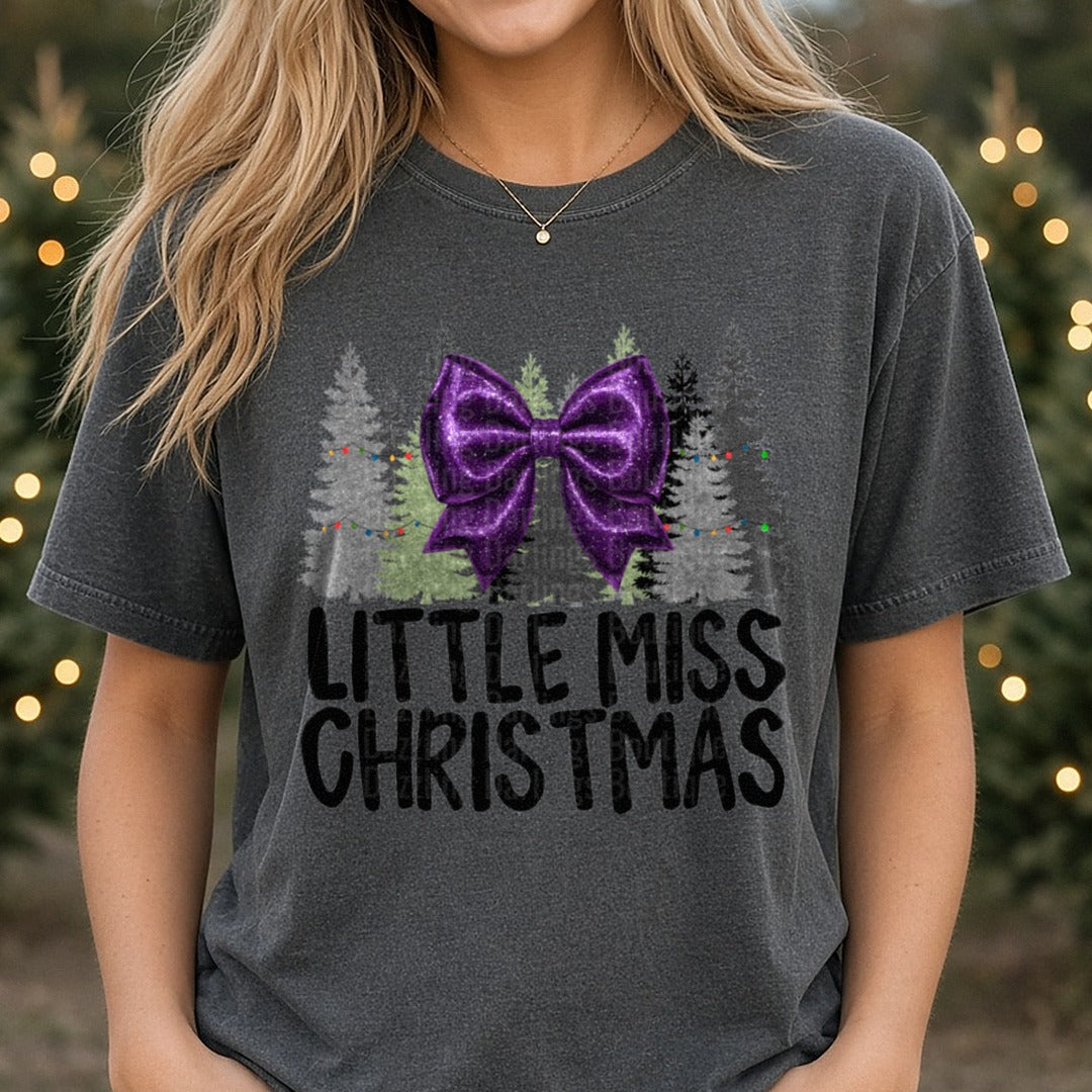 Purple Bow Little Miss Christmas DTF transfer shown on a Comfort Colors tee