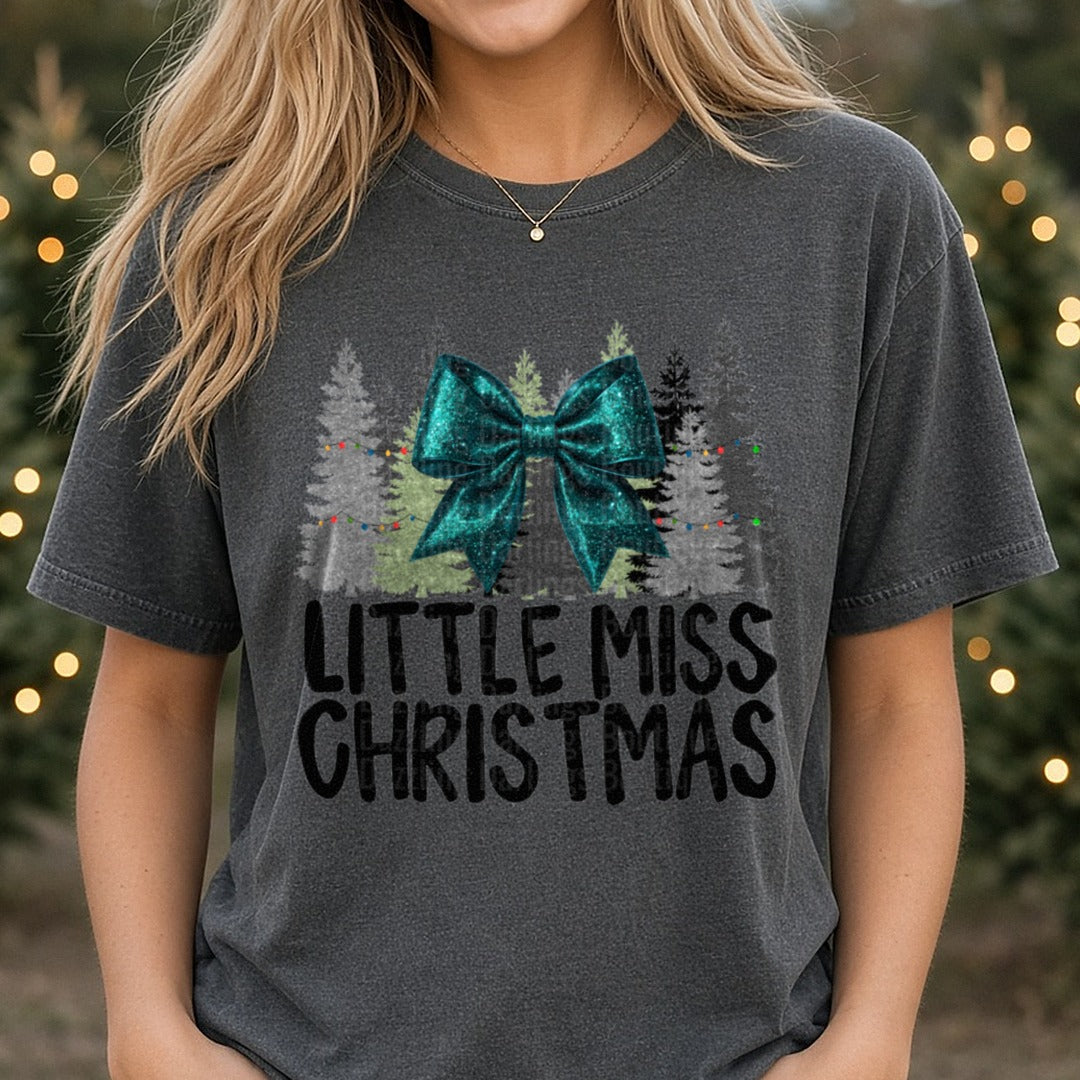 Teal Bow Little Miss Christmas DTF transfer shown on a Comfort Colors tee