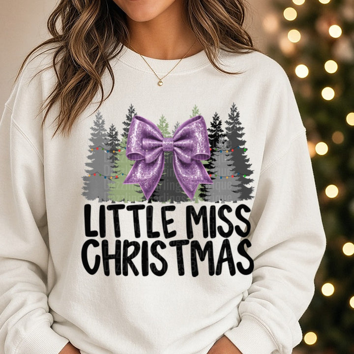 Lilac Bow Little Miss Christmas DTF transfer shown on a Comfort Colors sweatshirt