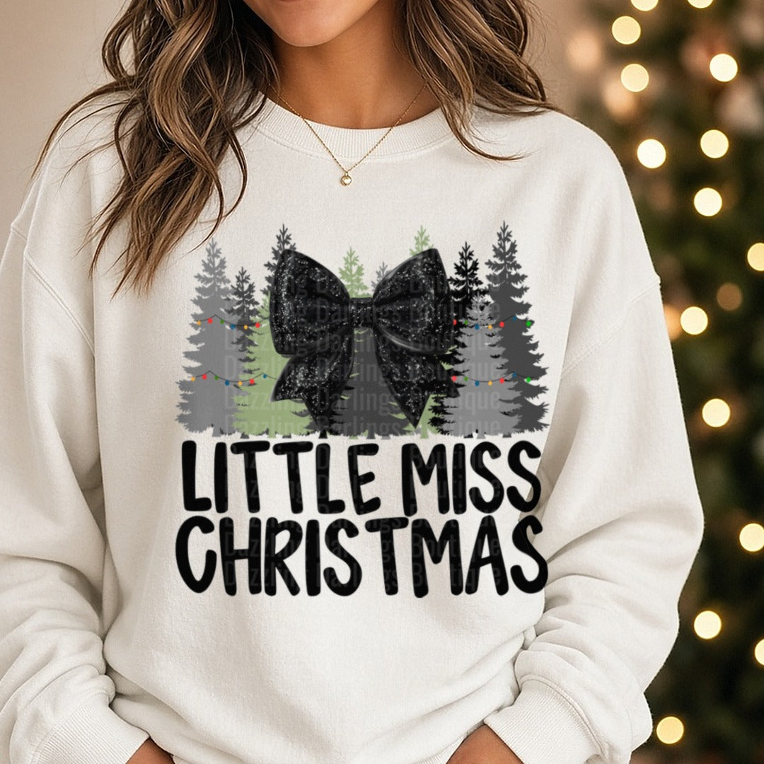 Black Bow Little Miss Christmas DTF transfer shown on a Comfort Colors sweatshirt
