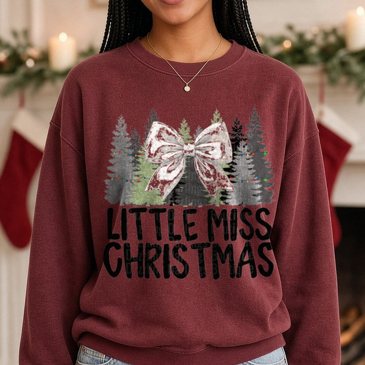 Cream Bow Little Miss Christmas DTF transfer shown on a Comfort Colors sweatshirt