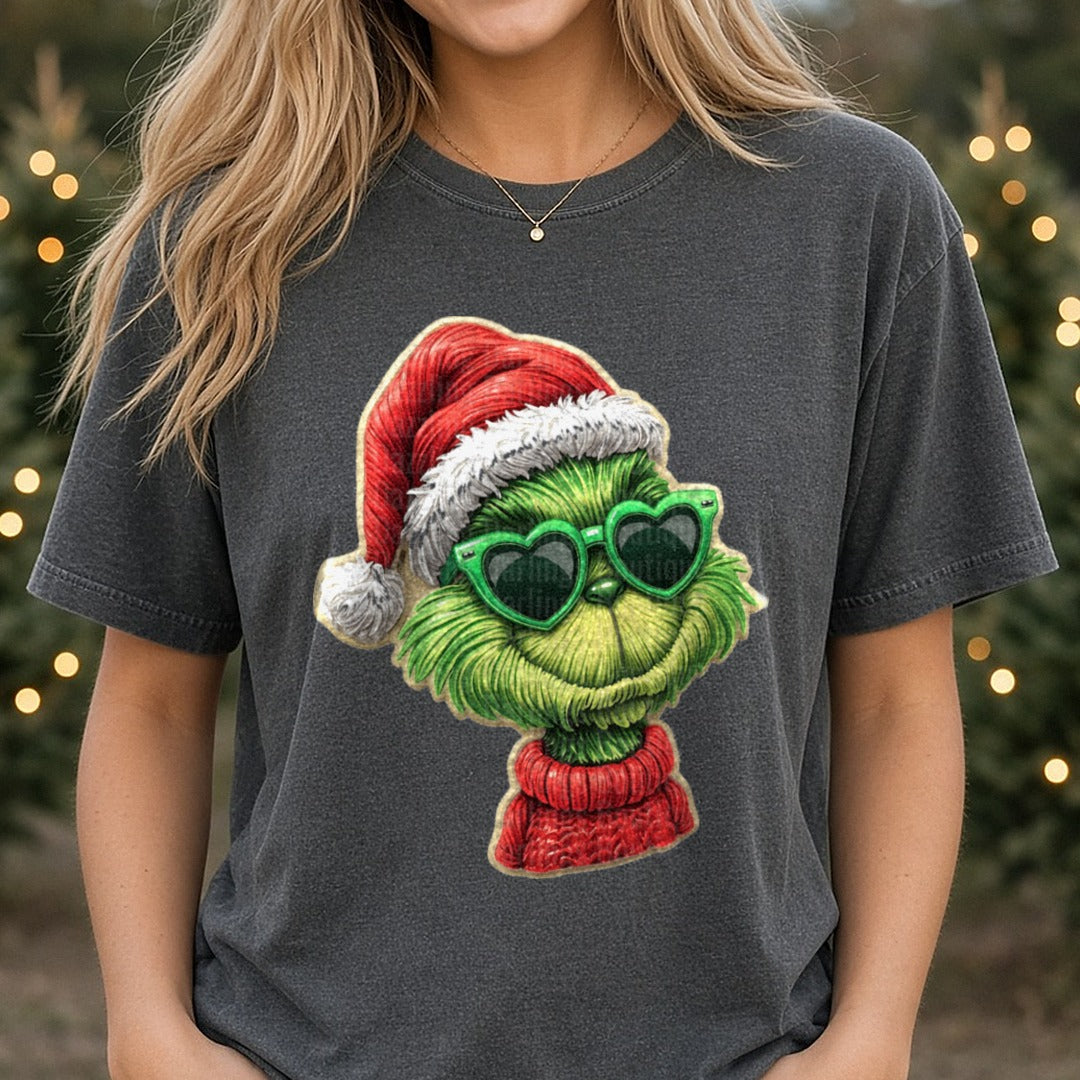 Christmas Character G Green Glasses Faux Detailed (1) DTF transfer shown on a Comfort Colors tee