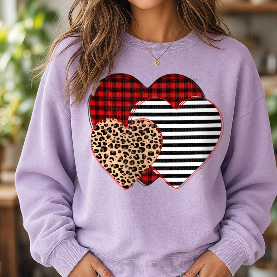 Buffalo Plaid Leopard Striped Valentine Hearts DTF transfer shown on a Comfort Colors sweatshirt