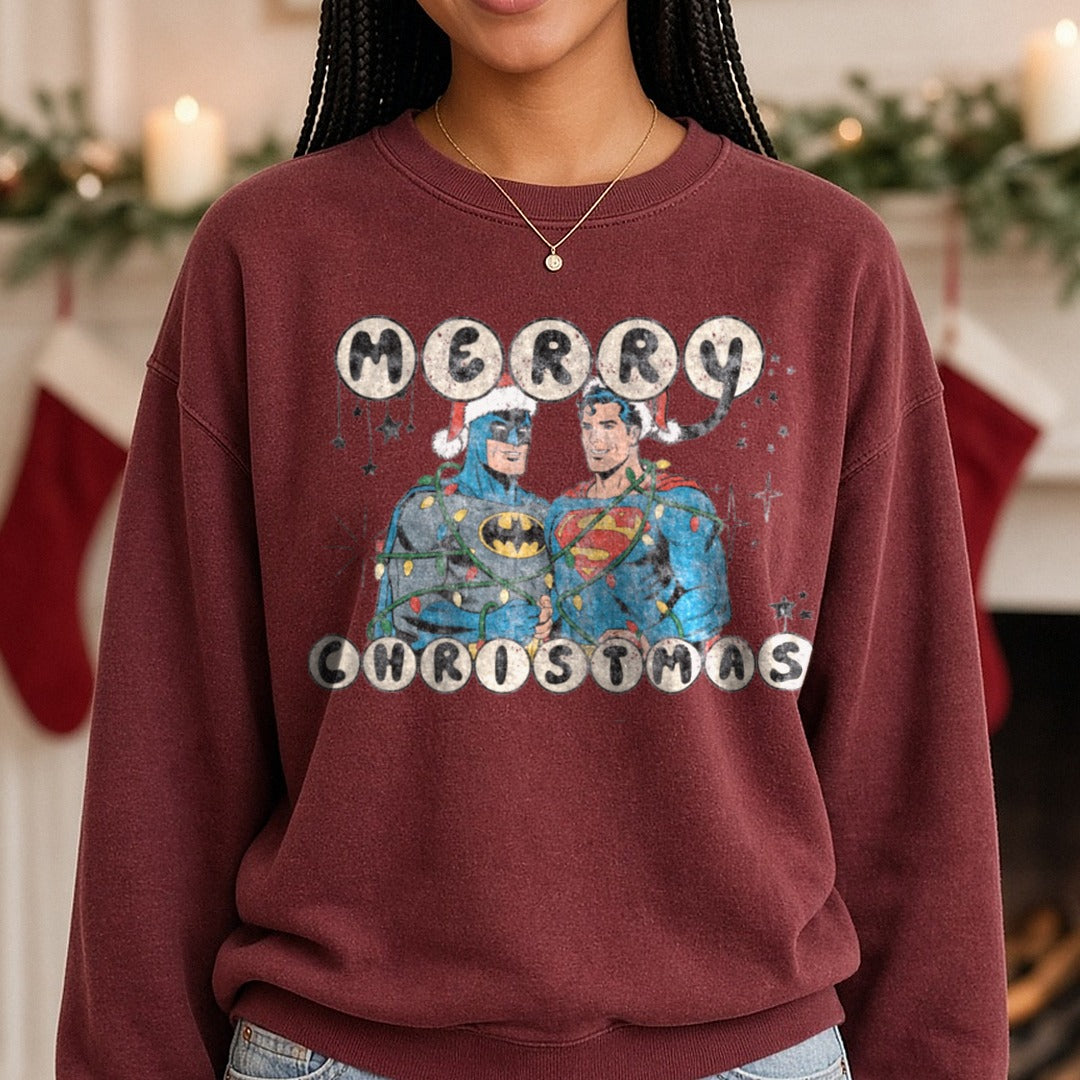 Merry Christmas Batman and Superman DTF transfer shown on a Comfort Colors sweatshirt