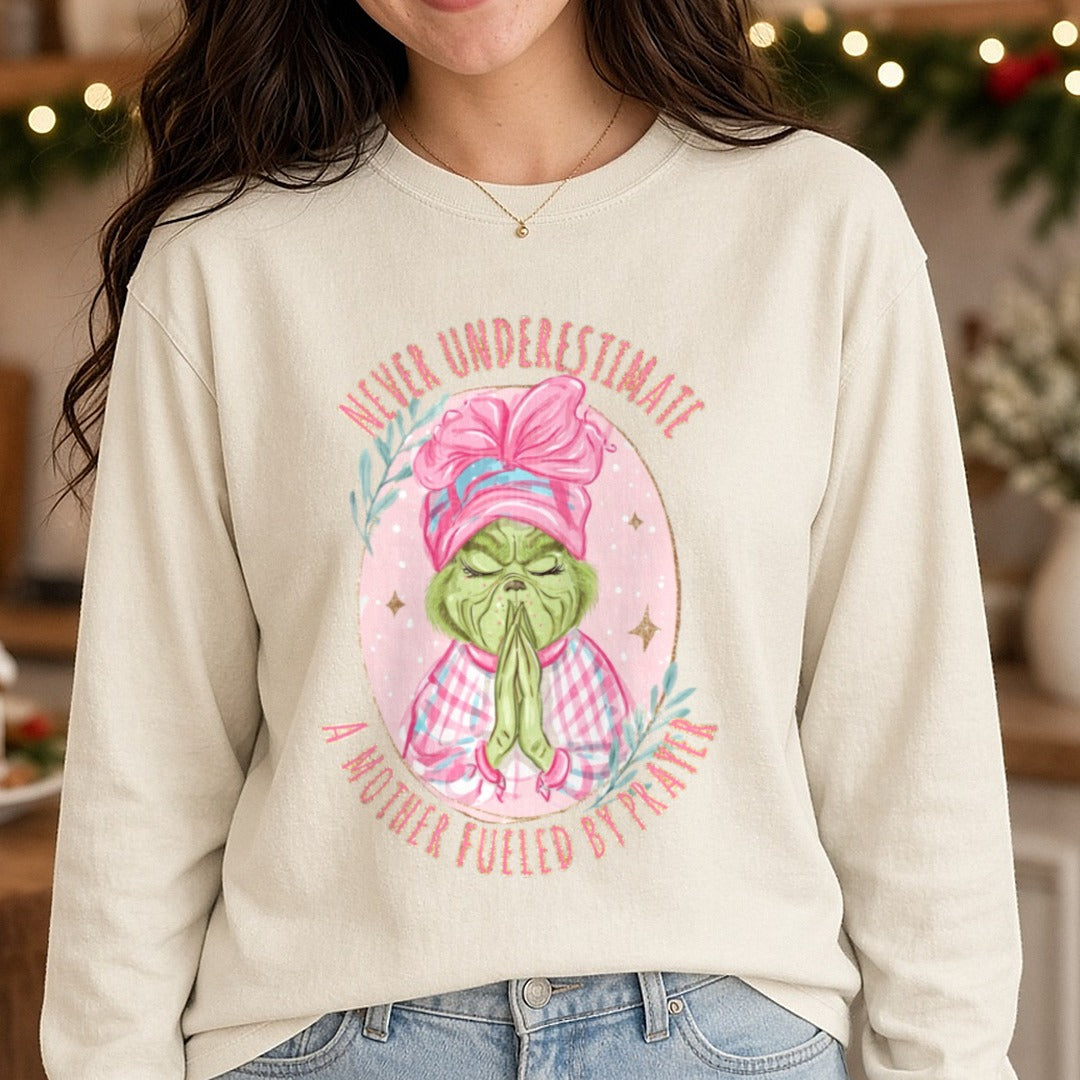 Praying grinch DTF transfer shown on a Comfort Colors long sleeve tee
