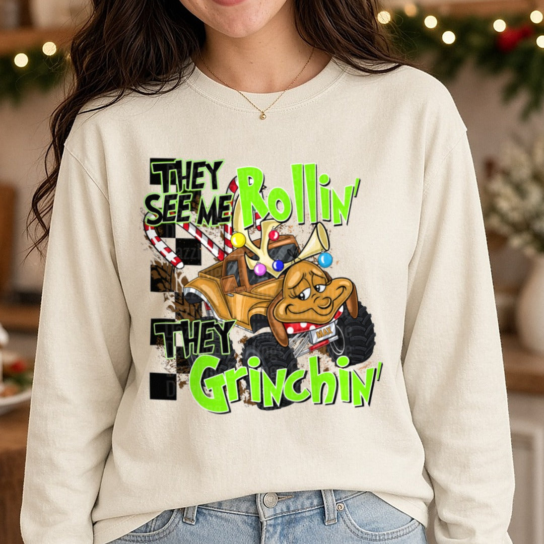 They See Me Rollin' They Grinchin' Dog Monster Truck Christmas DTF transfer shown on a Comfort Colors long sleeve tee