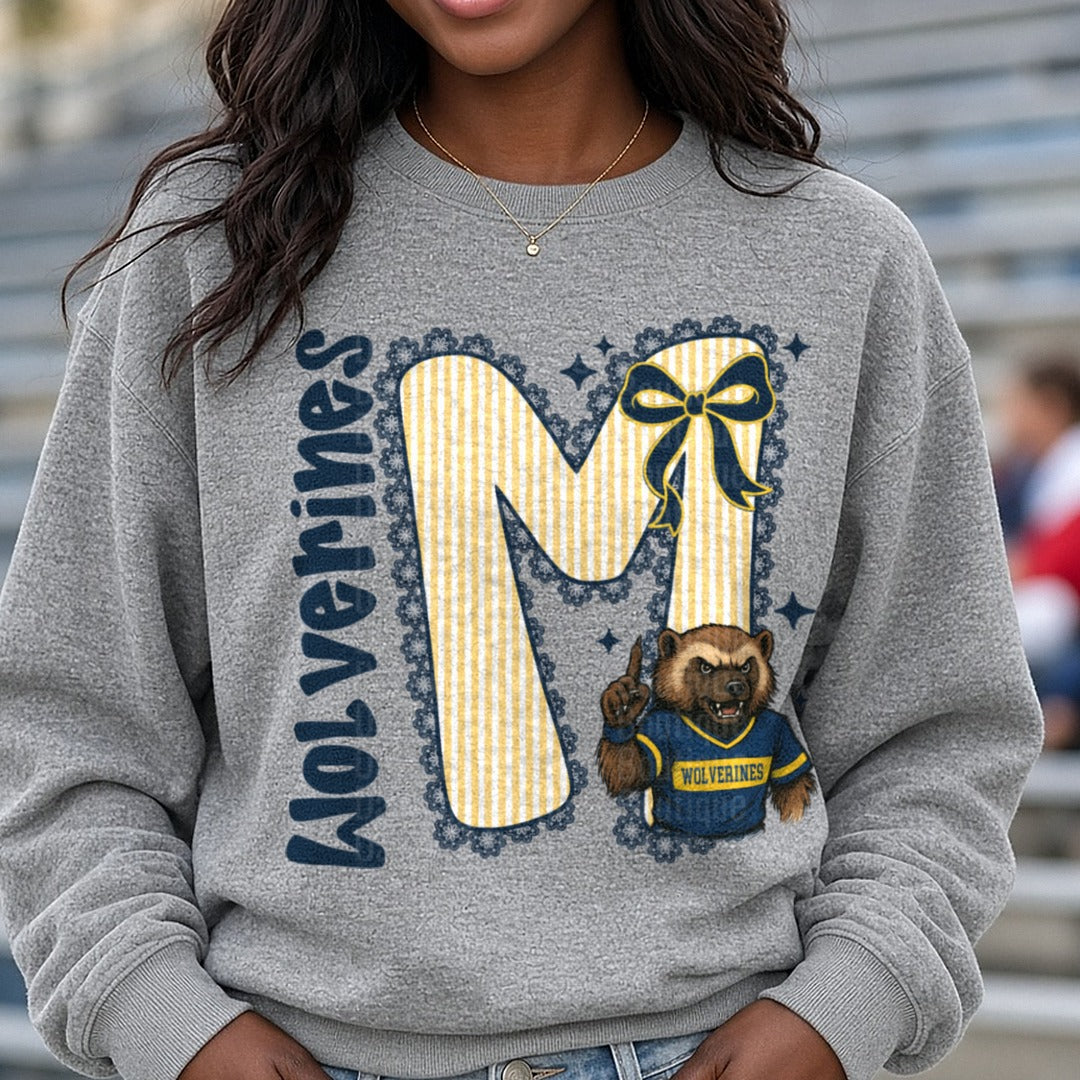 Wolverines Letter M Navy Bow Mascot DTF transfer shown on a Comfort Colors sweatshirt