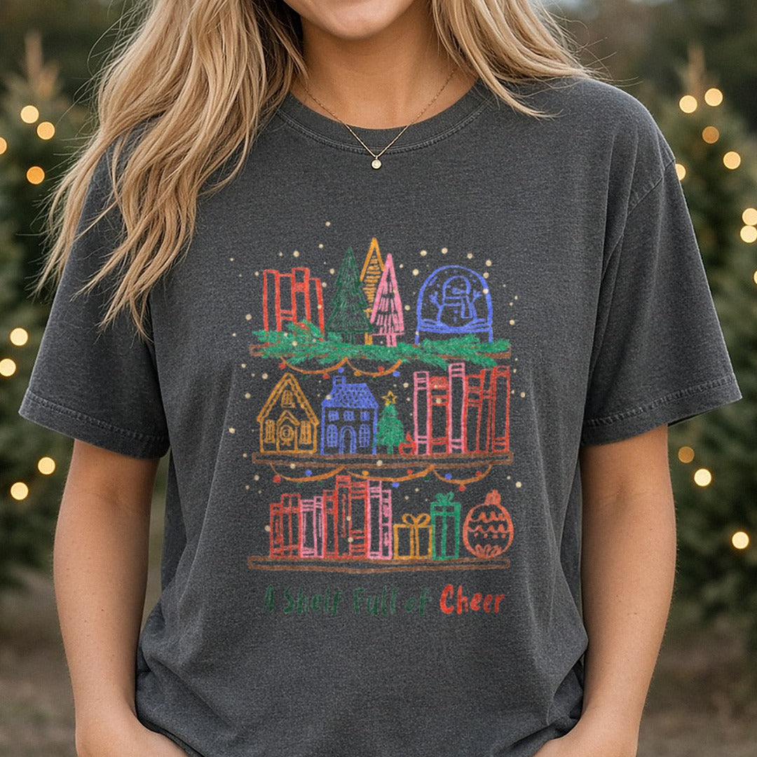 A SHELF FULL OF CHEER Christmas Book DTF transfer shown on a Comfort Colors tee