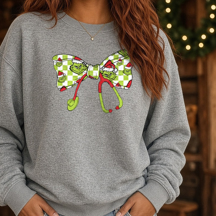 grinch stethoscope bow DTF transfer shown on a Comfort Colors sweatshirt