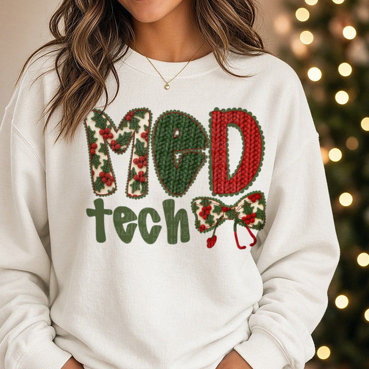 Med Tech Christmas Knit Holly Letters Plaid Bow DTF transfer shown on a Comfort Colors sweatshirt