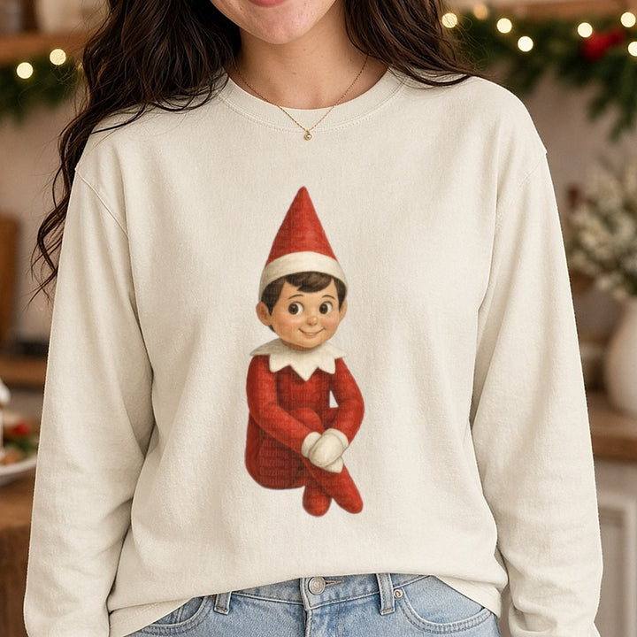 Boy Elf Sitting Full Body DTF transfer shown on a Comfort Colors long sleeve tee