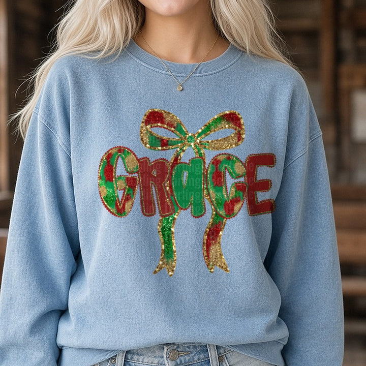 Grace Christmas Glitter Bow Plaid Letters DTF transfer shown on a Comfort Colors sweatshirt