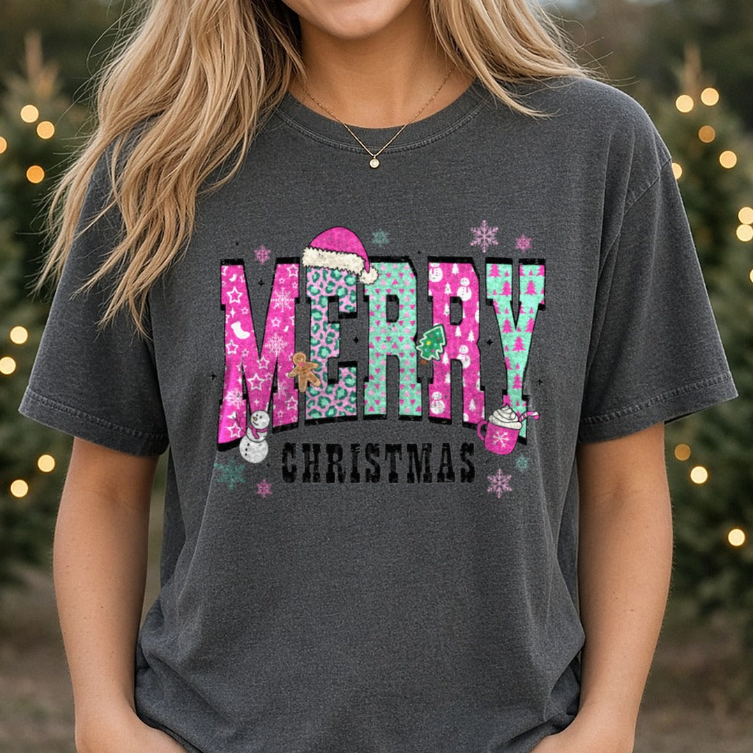 Merry Christmas Pink Teal Patterned Letters Snowman DTF transfer shown on a Comfort Colors tee