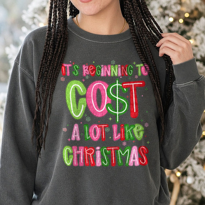 Cost a Lot Like Christmas DTF transfer shown on a Comfort Colors sweatshirt