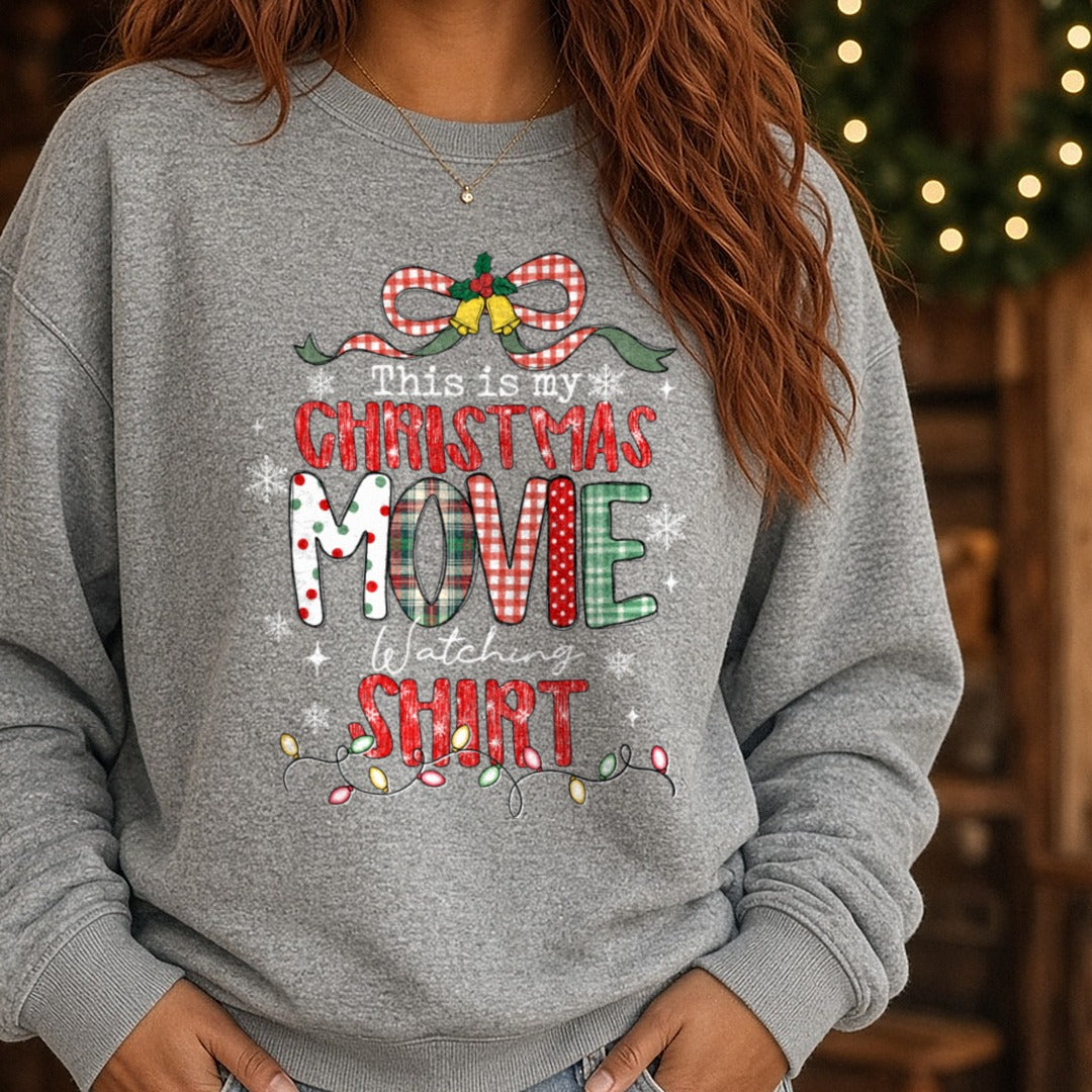 Christmas Movie Shirt Polka Dot Plaid Letters Script Watching DTF transfer shown on a Comfort Colors sweatshirt