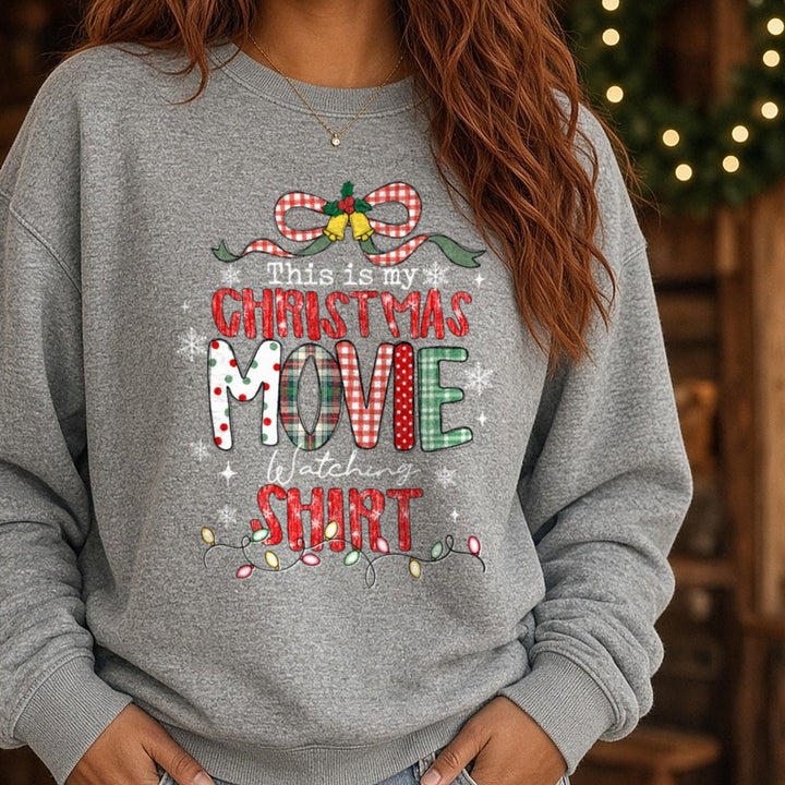 Christmas Movie Shirt Polka Dot Plaid Letters Script Watching DTF transfer shown on a Comfort Colors sweatshirt
