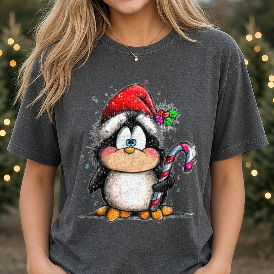 Hand-drawn Christmas Penguin Santa Hat Candy Cane Standing DTF transfer shown on a Comfort Colors tee