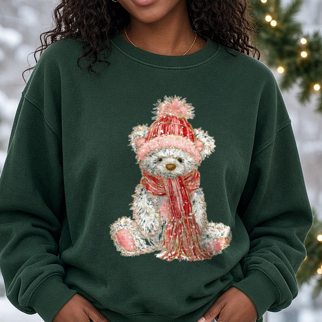 Christmas Teddy Bear Pink Pom Beanie Sitting DTF transfer shown on a Comfort Colors sweatshirt
