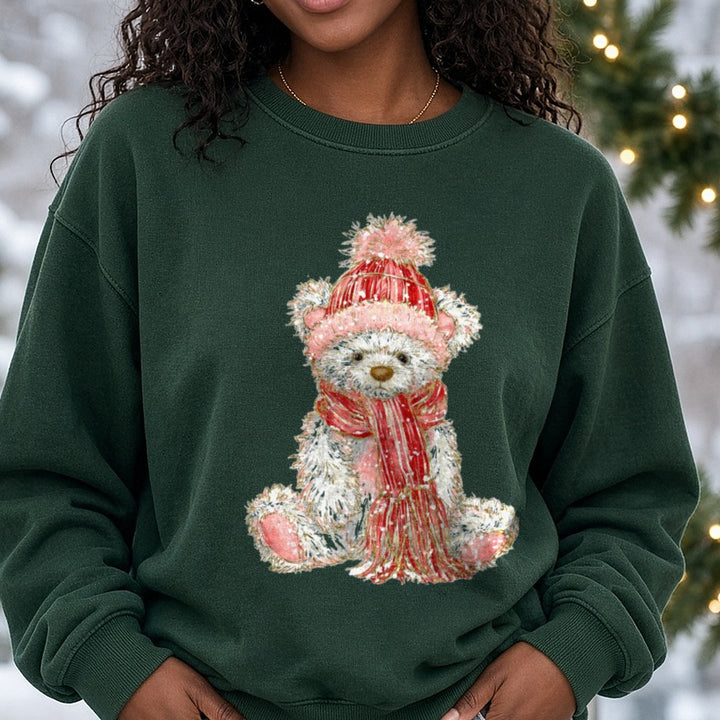 Christmas Teddy Bear Pink Pom Beanie Sitting DTF transfer shown on a Comfort Colors sweatshirt
