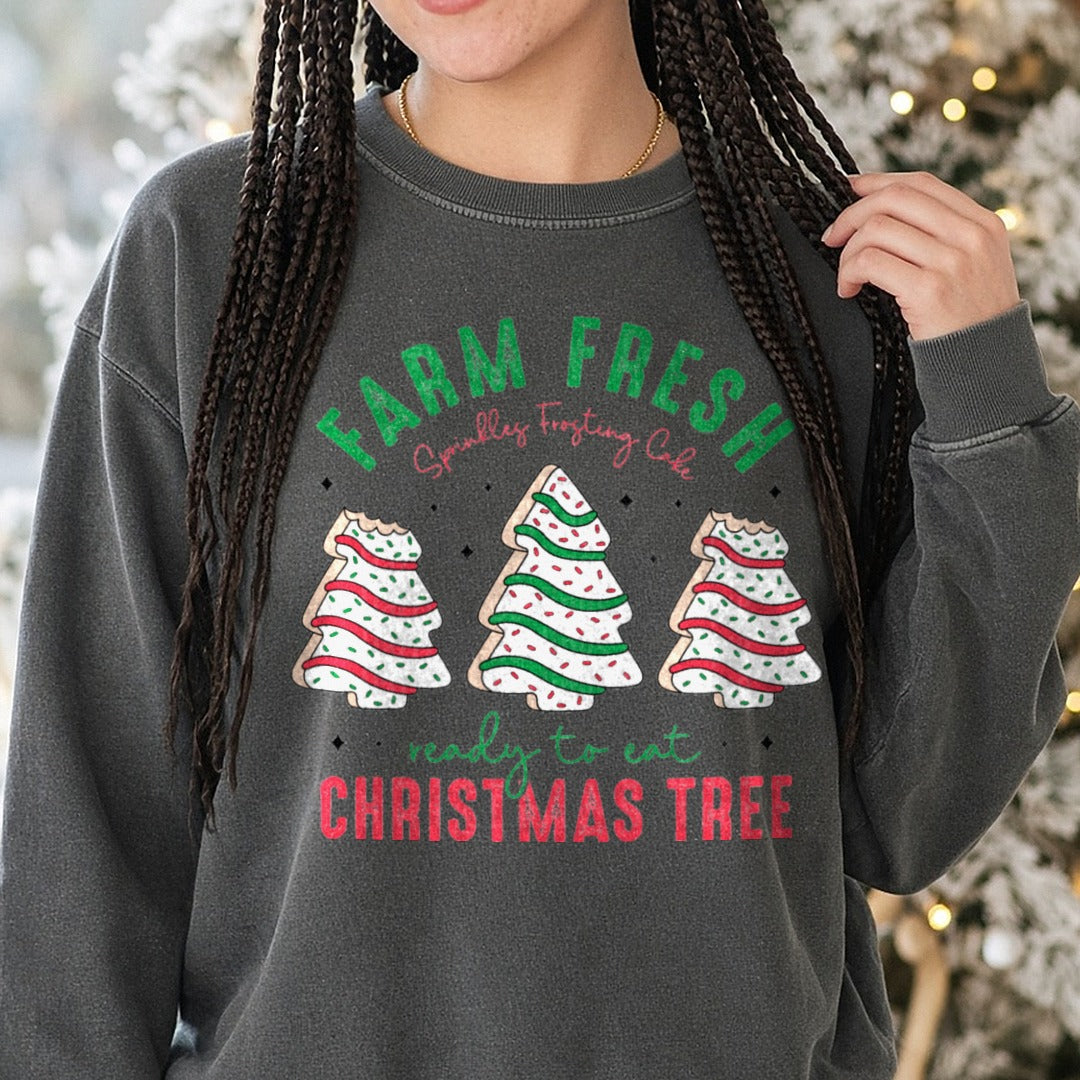 Farm Fresh Christmas Tree Cakes Green Red Bold Letters DTF transfer shown on a Comfort Colors sweatshirt