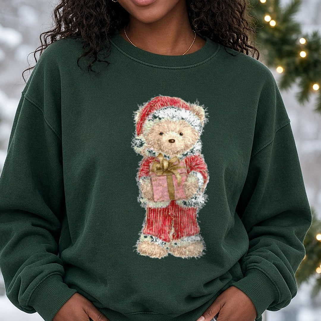 Christmas Teddy Bear Santa Hat Holding Pink Gift DTF transfer shown on a Comfort Colors sweatshirt