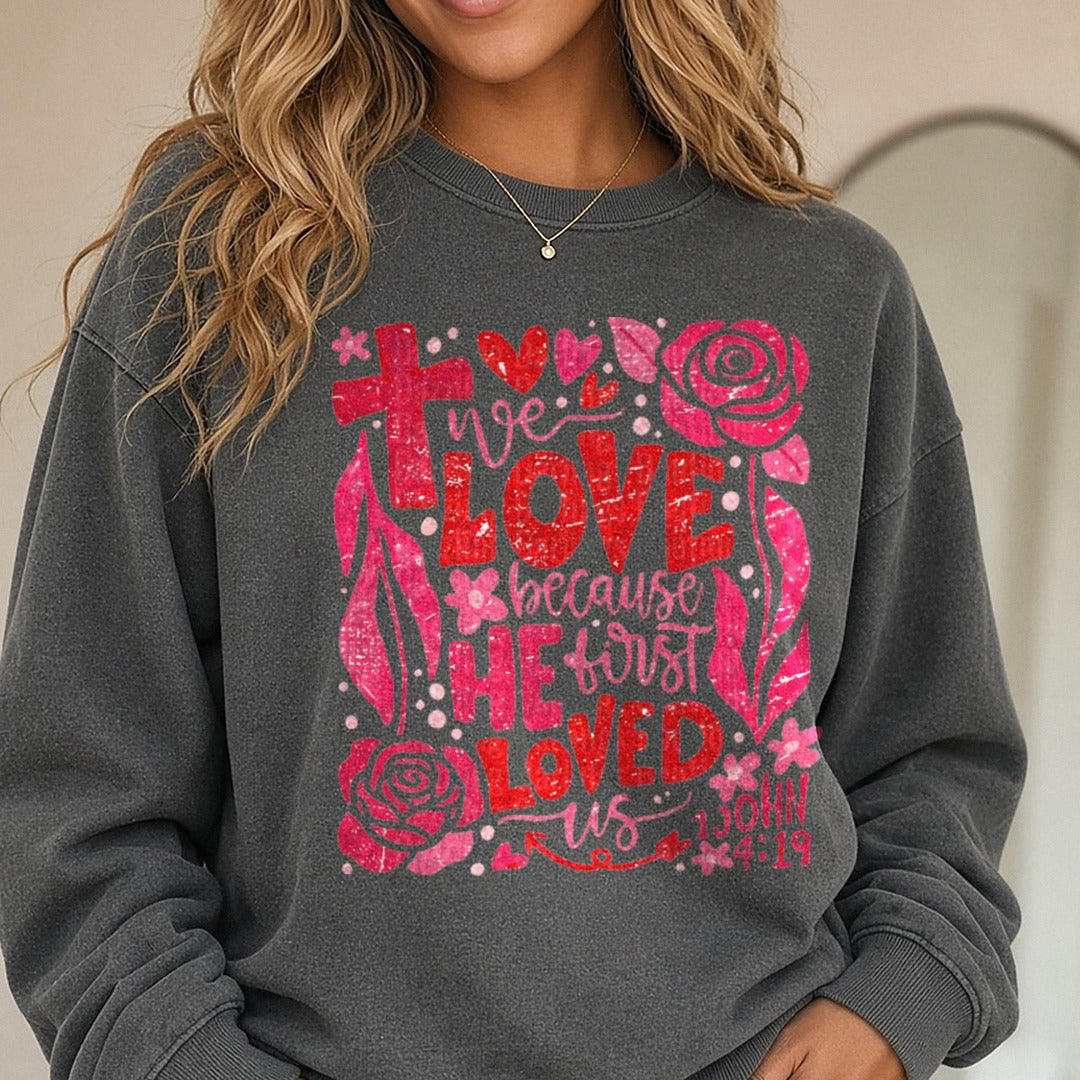 Valentines Day We Love Because He First Loved US DTF transfer shown on a Comfort Colors sweatshirt