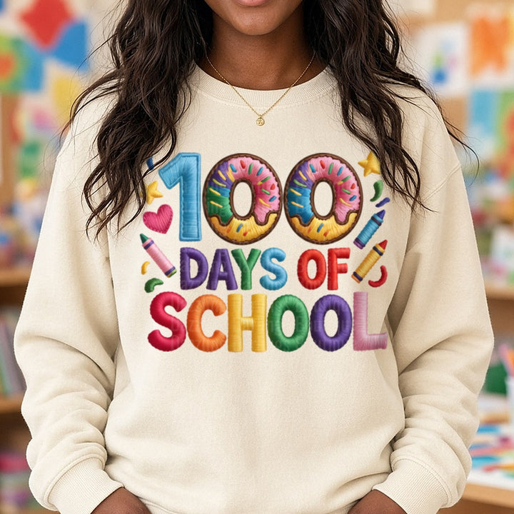 100 Days Of School Sprinkle Donut Embroidered Letters DTF transfer shown on a Comfort Colors sweatshirt