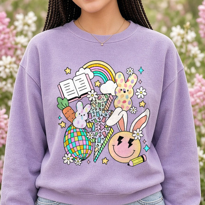 Easter Bunny Teacher School Supplies Rainbow Flowers DTF transfer shown on a Comfort Colors sweatshirt