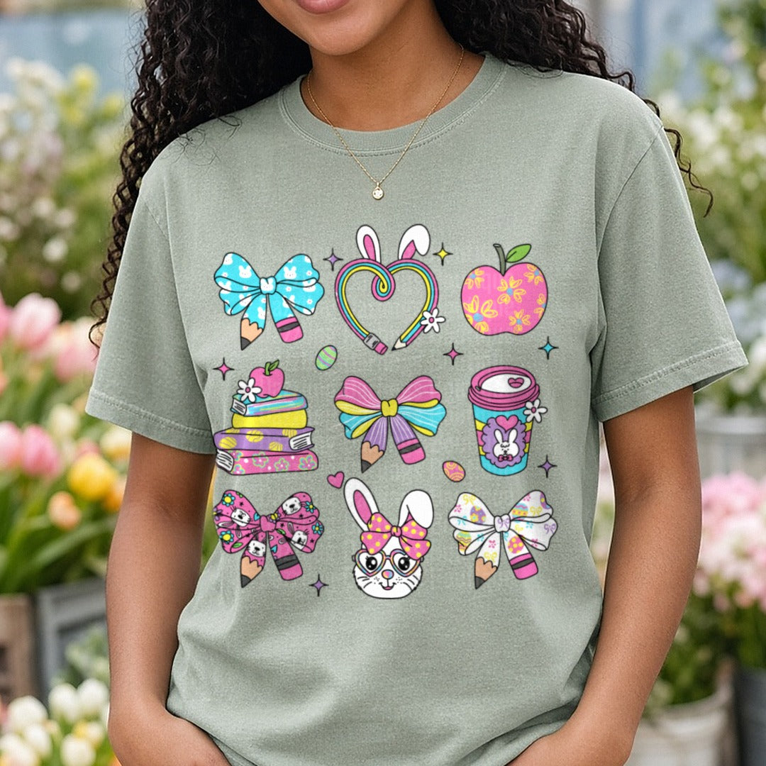Cute School Supplies with Bunny Ears Hair Bows and Rainbow Hearts DTF transfer shown on a Comfort Colors tee