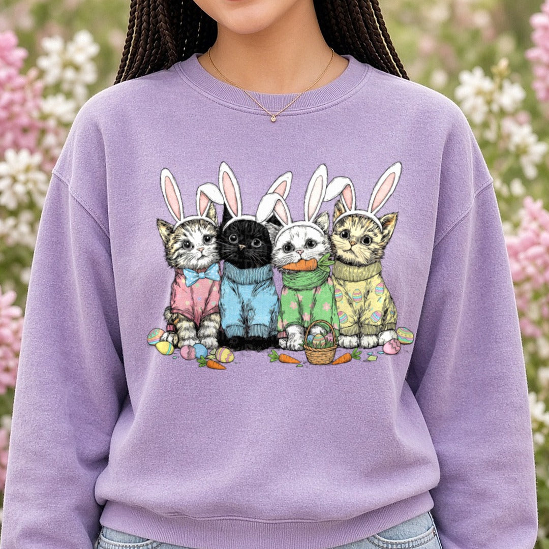 Five Cute Cats Wearing Easter Bunny Ears with Colored Eggs DTF transfer shown on a Comfort Colors sweatshirt