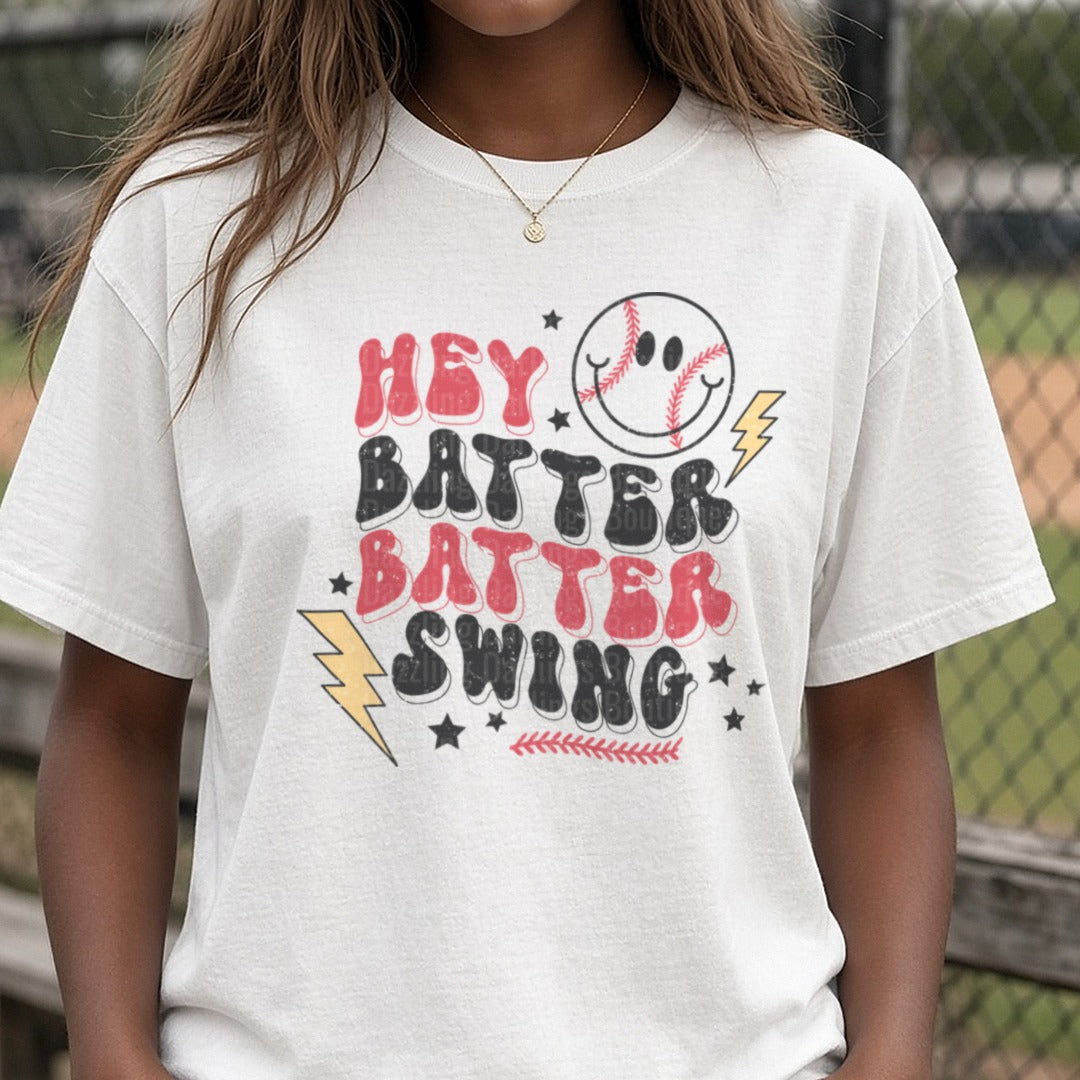 Hey Batter Batter Swing Baseball Smiley Face Lightning Stars DTF transfer shown on a Comfort Colors tee