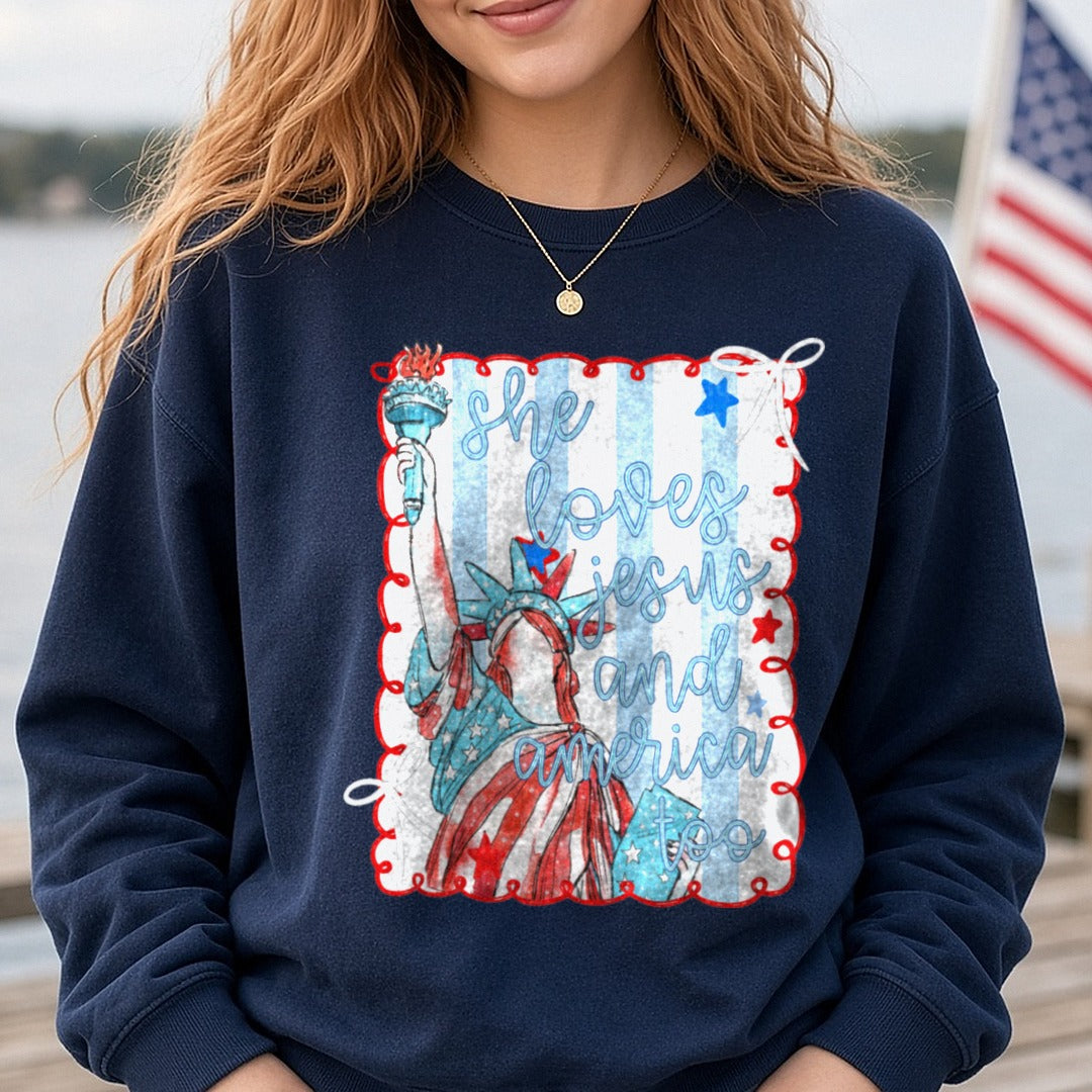 She Loves Jesus and America Too Statue of Liberty Patriotic DTF transfer shown on a Comfort Colors sweatshirt