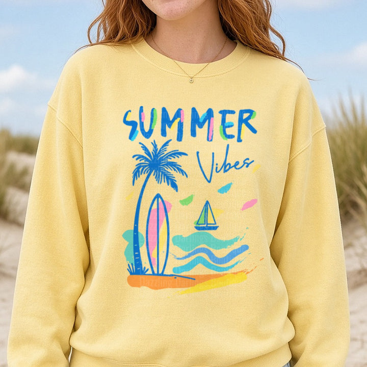 Summer Vibes Palm Tree Surfboard Beach Scene with Sailboat DTF transfer shown on a Comfort Colors sweatshirt