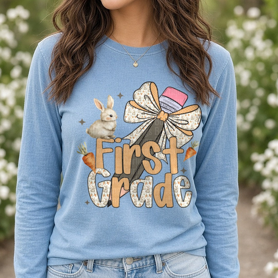 First Grade Back to School Bunny with Bow and Carrots DTF transfer shown on a Comfort Colors long sleeve tee