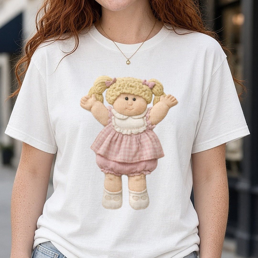 Cabbage Patch Kids Blonde Pigtail Girl in Pink Dress DTF transfer shown on a Comfort Colors tee