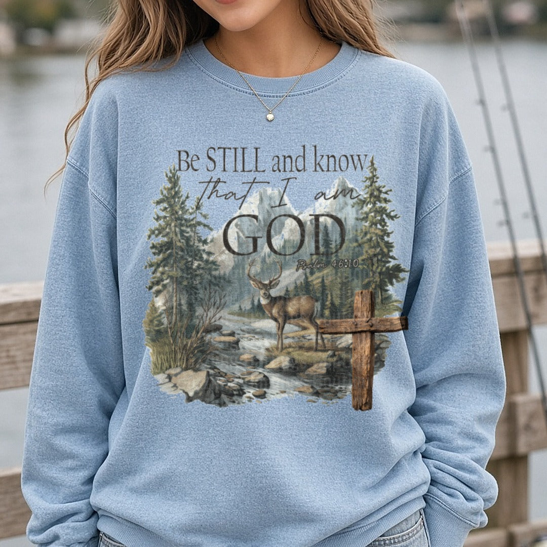 Be Still and Know That I Am God Psalm 46:10 Deer Cross Mountain Scene DTF transfer shown on a Comfort Colors sweatshirt