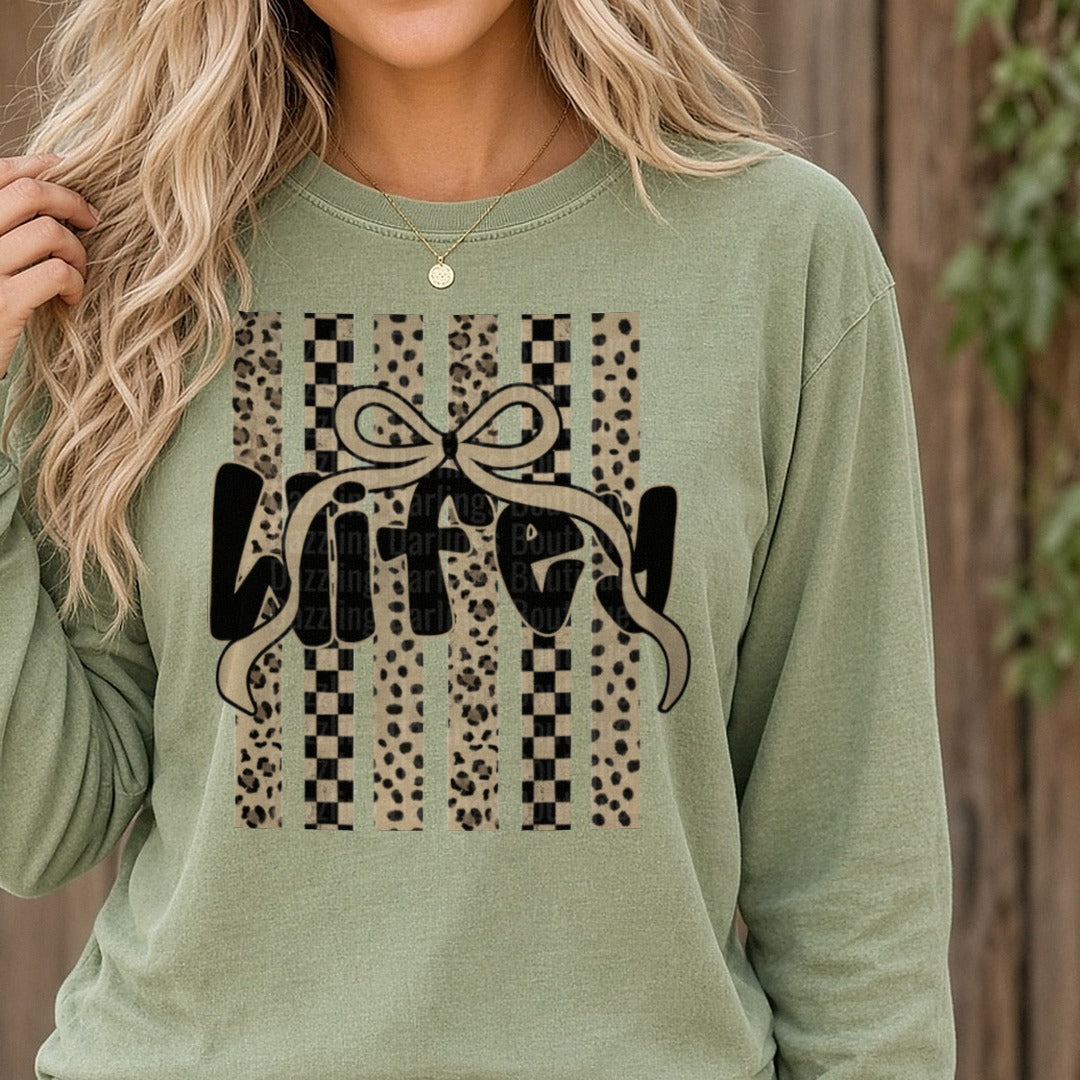 Wifey Text with Bow on Leopard Print and Checkered Stripes DTF transfer shown on a Comfort Colors long sleeve tee
