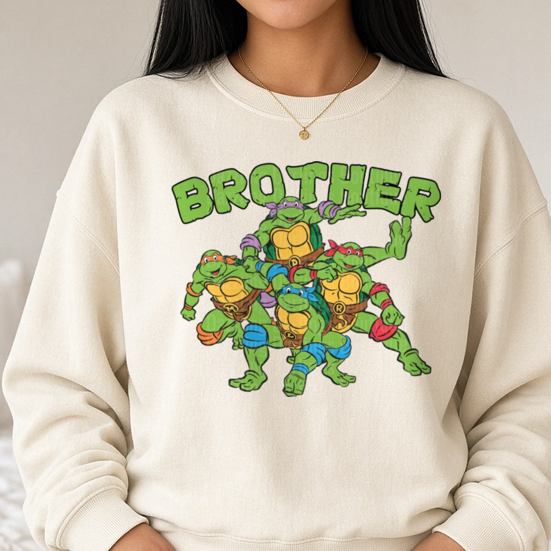 TMNT Brother Teenage Mutant Ninja Turtles Group Design DTF transfer shown on a Comfort Colors sweatshirt