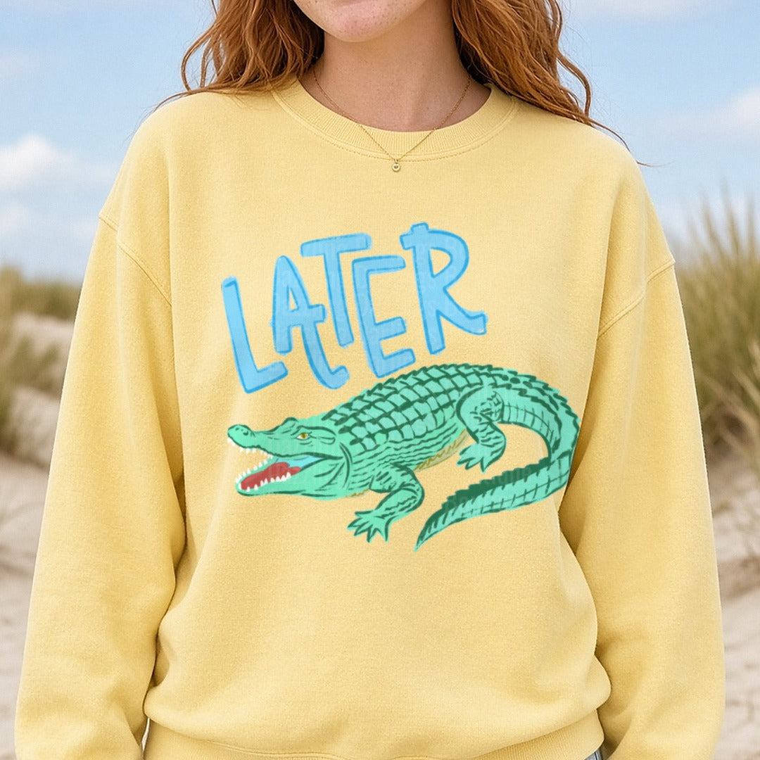 Later Alligator Blue Text with Green Cartoon Gator DTF transfer shown on a Comfort Colors sweatshirt