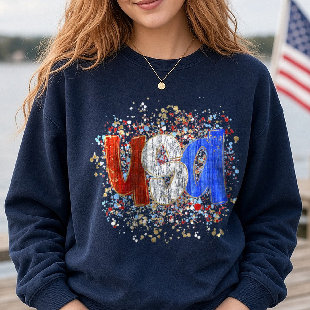 USA Patriotic Letters with Red White Blue Paint Splatter DTF transfer shown on a Comfort Colors sweatshirt