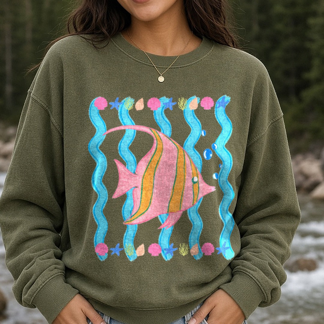 Tropical Fish Swimming Among Coral Seaweed and Bubbles DTF transfer shown on a Comfort Colors sweatshirt