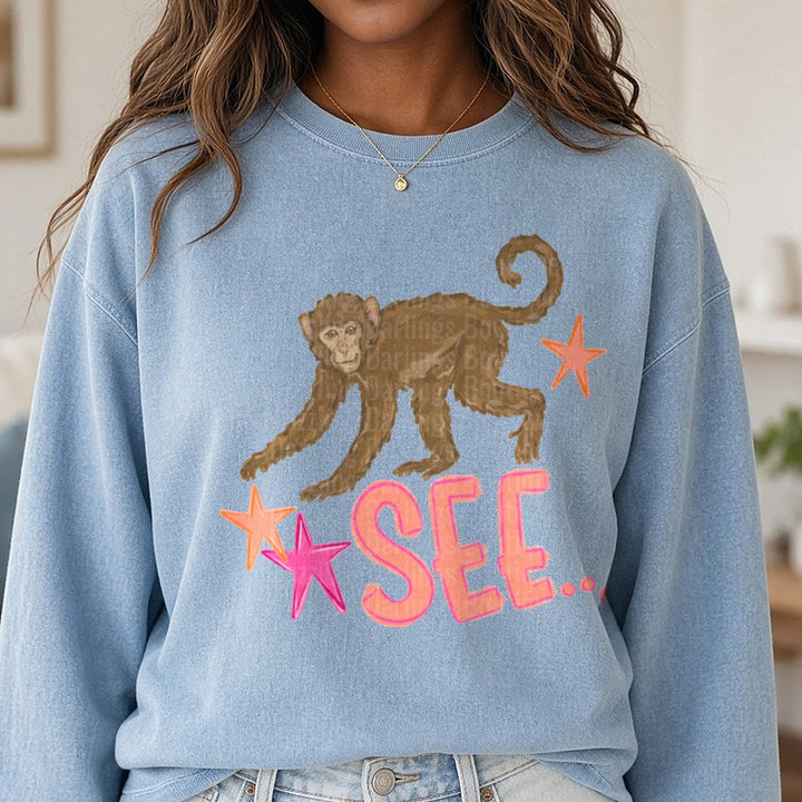 Brown Monkey with Pink Stars and SEE Text Design DTF transfer shown on a Comfort Colors sweatshirt