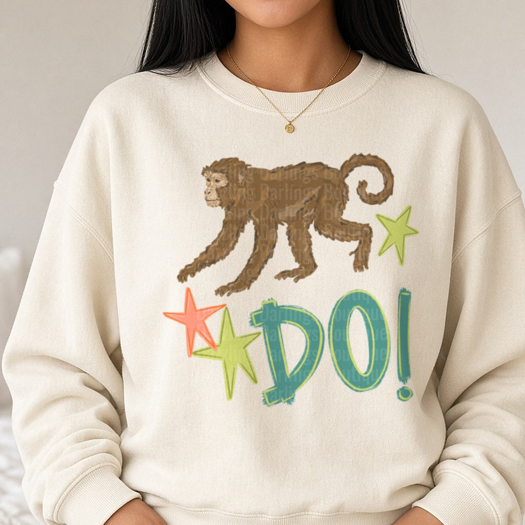 Brown Monkey with Colorful Stars and DO! Text DTF transfer shown on a Comfort Colors sweatshirt