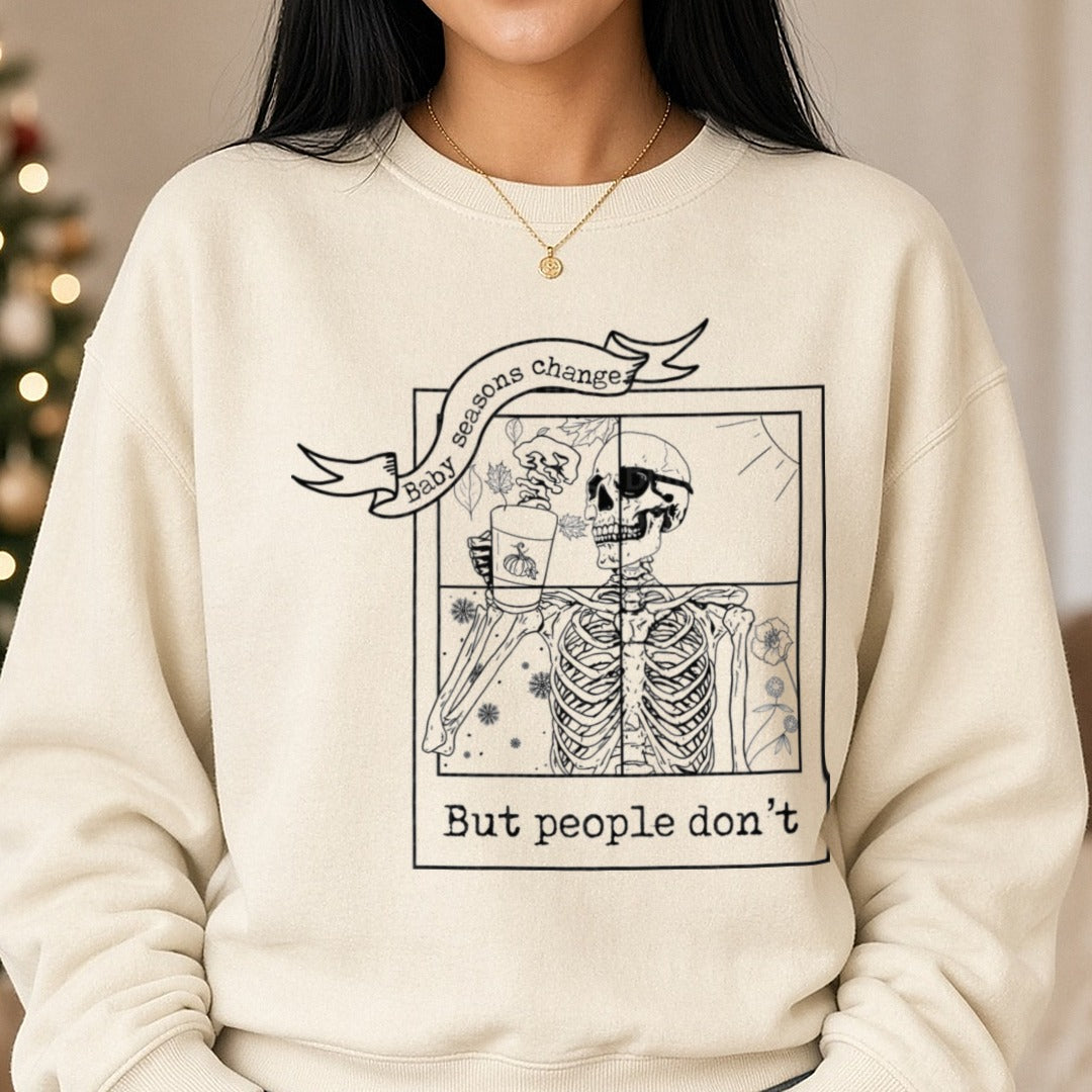 Baby Seasons Change But People Don't Skeleton Autumn Winter Split Design DTF transfer shown on a Comfort Colors sweatshirt