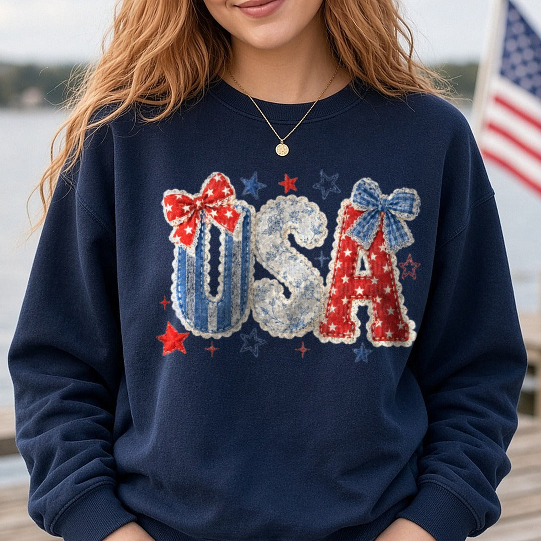 Patriotic USA Letters Fabric Applique Bows Stars Red White Blue DTF transfer shown on a Comfort Colors sweatshirt
