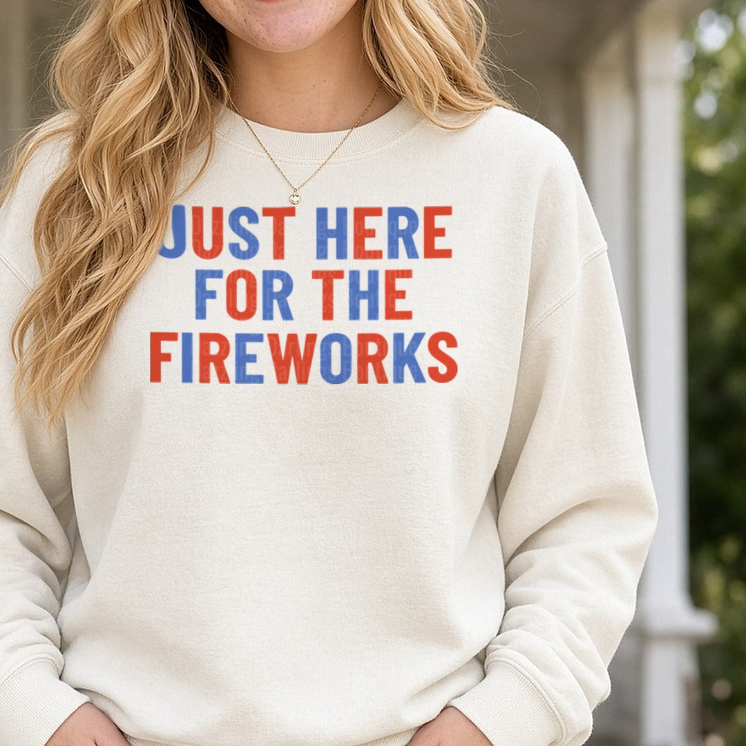 Just Here For The Fireworks Red White Blue Bold Text DTF transfer shown on a Comfort Colors sweatshirt