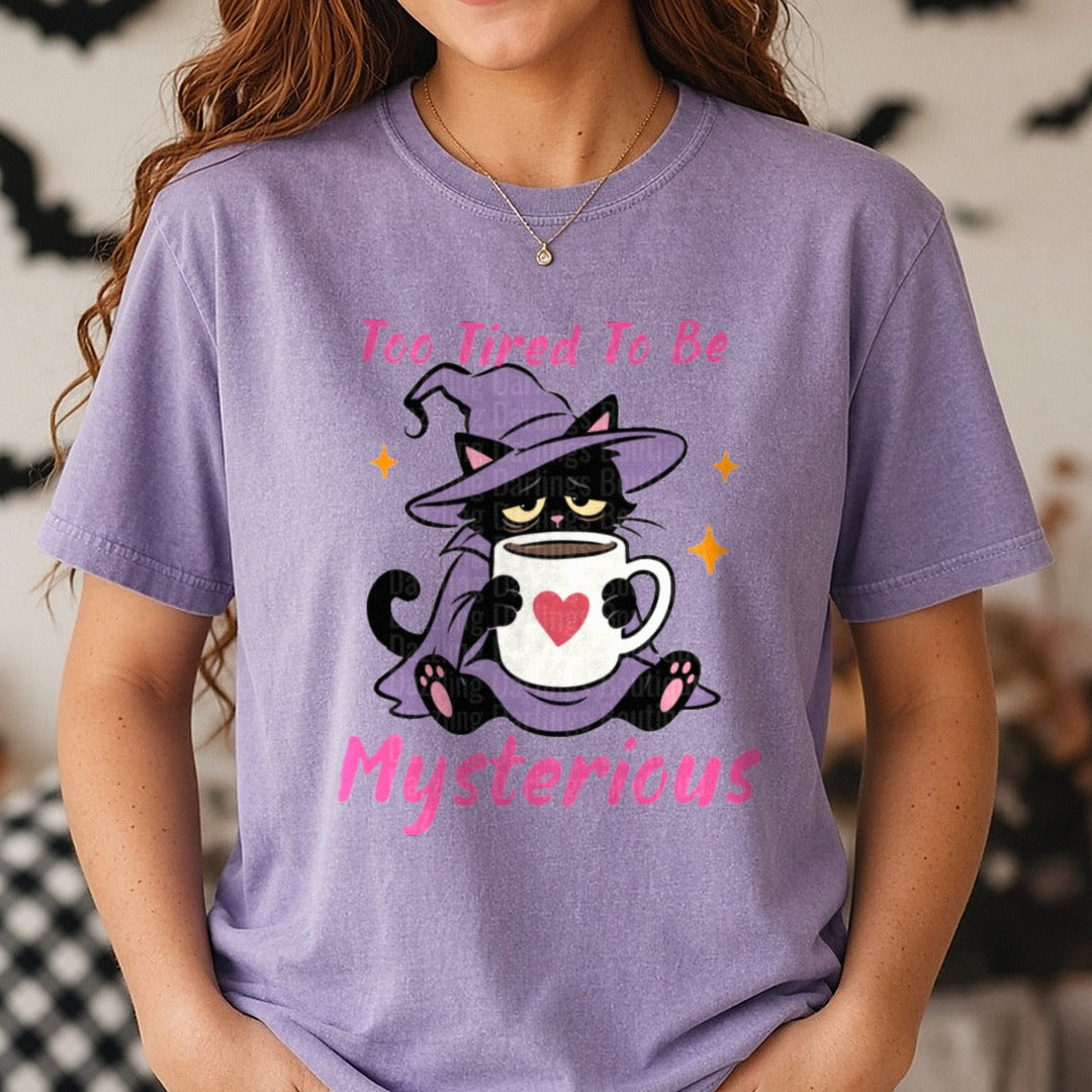 Too Tired To Be Mysterious Grumpy Black Cat Witch Coffee DTF transfer shown on a Comfort Colors tee