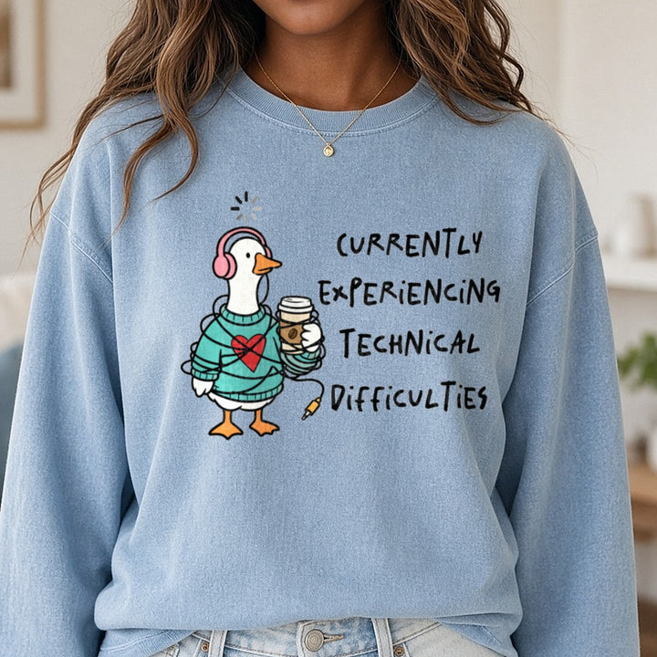 Goose in Sweater with Headphones Currently Experiencing Technical Difficulties DTF transfer shown on a Comfort Colors sweatshirt